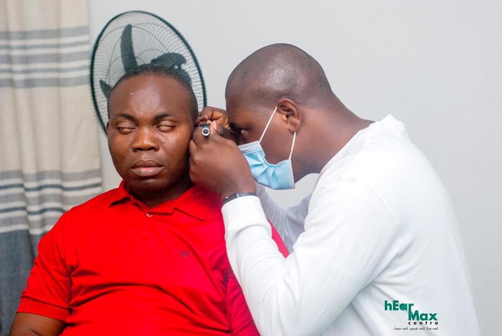 Clinician performing an otoscopic ear examination at HearMax Centre
