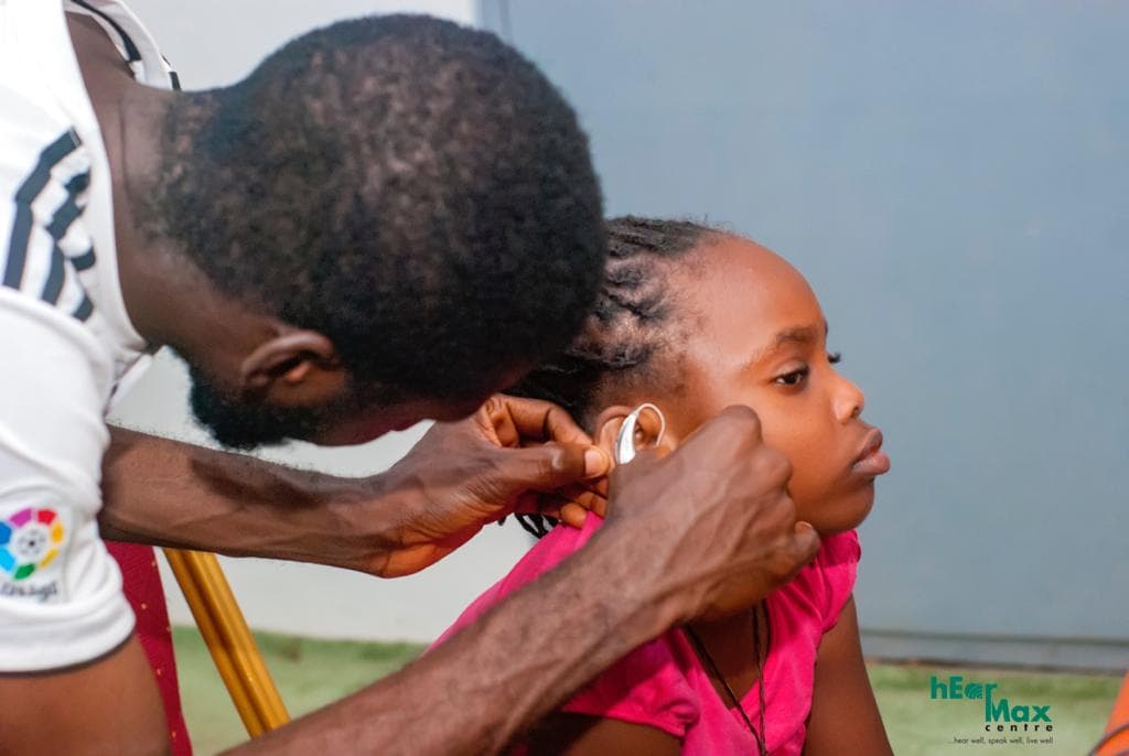 Child receiving a hearing screening at a community program