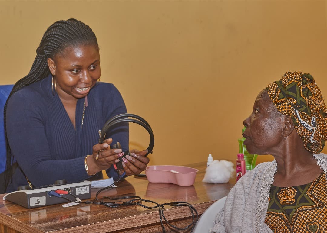 Older Nigerian adult in conversation with a family member
